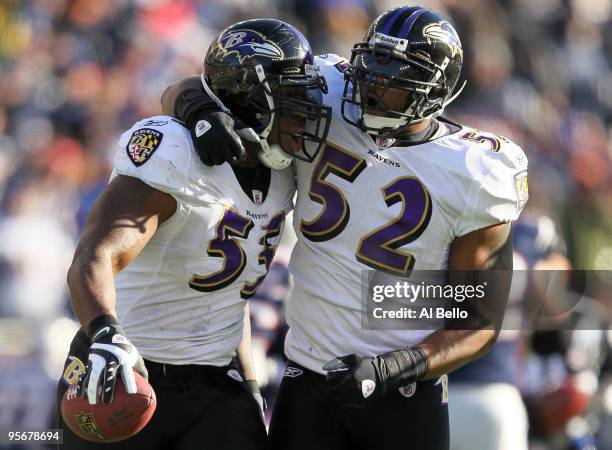 Terrell Suggs and Ray Lewis of the Baltimore Ravens celebrate after Suggs recovered his own forced fumble in the first quarter against the New...