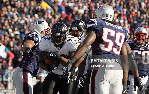 Le'Ron McClain of the Baltimore Ravens scores on a 1-yard touchdown run in the first quarter against the New England Patriots during the 2010 AFC...