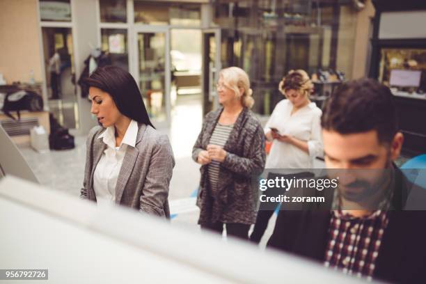 withdrawing money from atms - customers lining up stock pictures, royalty-free photos & images