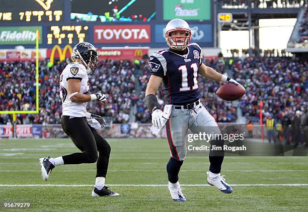 Julian Edelman of the New England Patriots reacts after he scored a 1-yard touchdown reception in the third quarter against Chris Carr of the...