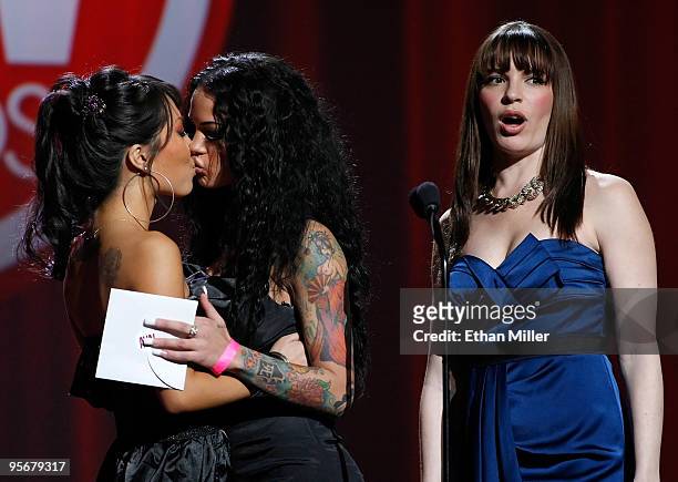 Adult film actresses Asa Akira and Angelina Valentine kiss as Dana DeArmond looks on as they present an award during the 27th annual Adult Video News...