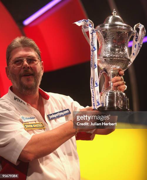Martin Adams of England poses with the trophy after beating Dave Chisnall of England in the Final of The World Professional Darts Championship at The...