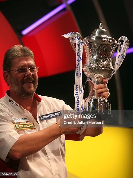 Martin Adams of England with the trophy after beating Dave Chisnall of England in the Final of The World Professional Darts Championship at The...