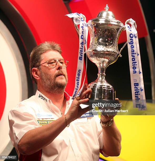 Martin Adams of England with the trophy after beating Dave Chisnall of England in the Final of The World Professional Darts Championship at The...