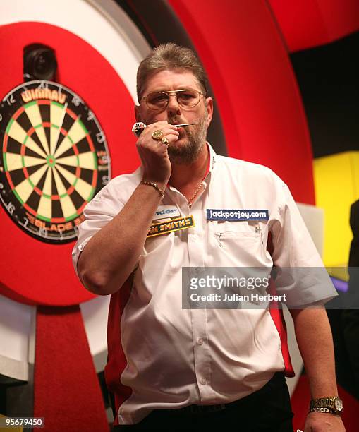 Martin Adams of England kisses a dart after beating Dave Chisnall of England in the Final of The World Professional Darts Championship at The...