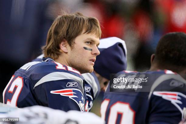 Tom Brady of the New England Patriots looks on from the bench dejected against the Baltimore Ravens during the 2010 AFC wild-card playoff game at...