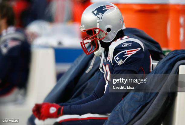 Randy Moss of the New England Patriots sits on the bench dejected late in the fourth quarter against the Baltimore Ravens during the 2010 AFC...