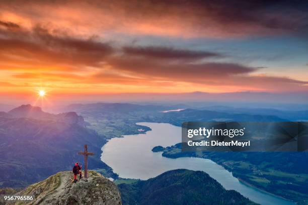 mountain climber enjoy the sunset at mount schafberg, - vocklabruck stock pictures, royalty-free photos & images