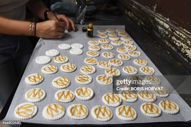 Pastry chef prepares biscuits in the form of the Olympique de Marseille logo on May 10 in Marseille, ahead of the UEFA Europa League final football...