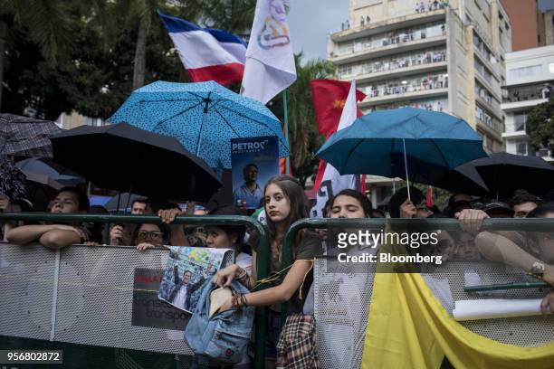 Supporters of Gustavo Petro, presidential candidate for the Progressivists Movement Party, shelter under umbrellas during a campaign rally in...