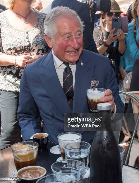 Prince Charles, Prince of Wales visits a café as he take a brief walking tour of the Kapnikarea Area of central Athens during his Royal visit to...