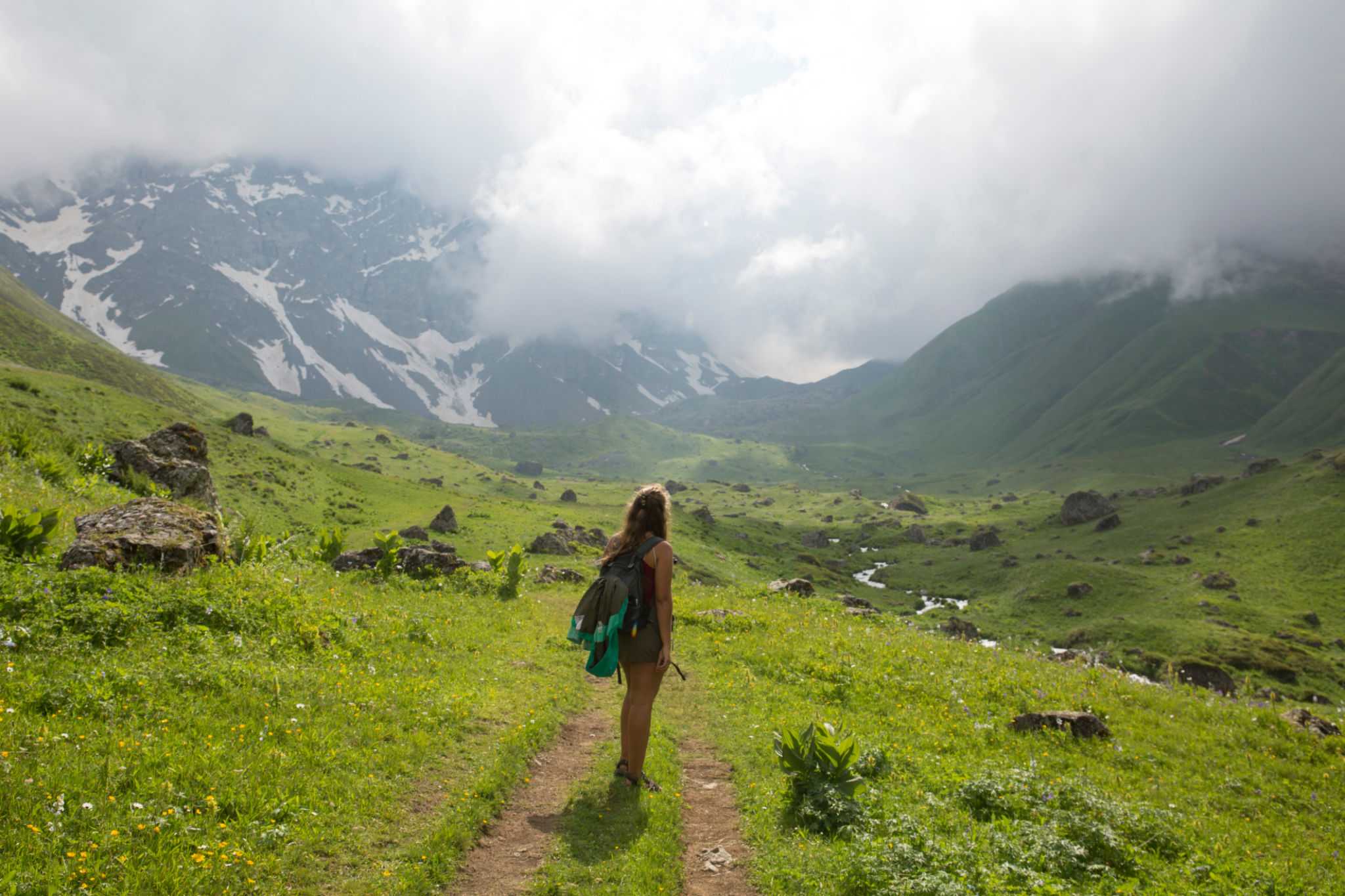 Young woman explores Caucasus mountains Young woman explores Caucasus mountains