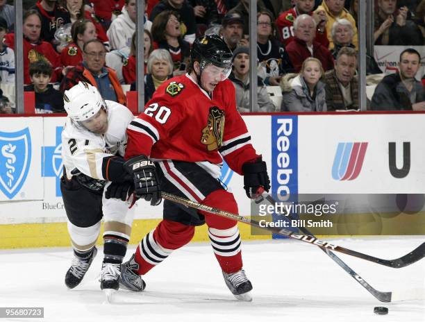 Jack Skille of the Chicago Blackhawks approaches the puck as Scott Niedermayer of the Anaheim Ducks reaches from behind on January 10, 2010 at the...