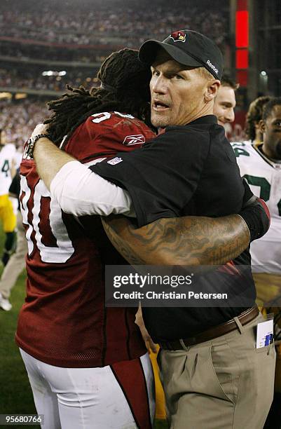 Head coach Ken Whisenhunt of the Arizona Cardinals hugs Darnell Dockett after they won the 2010 NFC wild-card playoff game 51-45 against the Green...