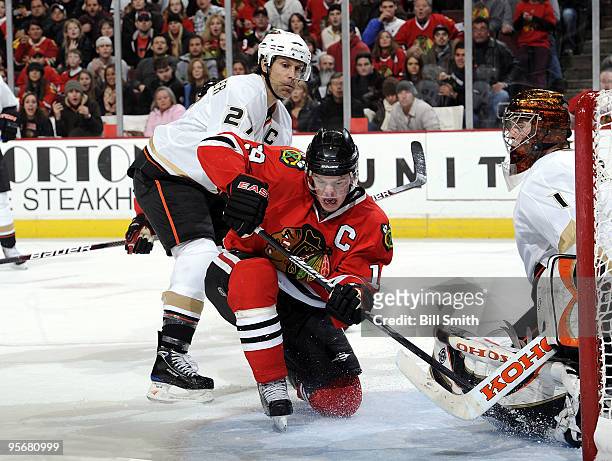 Jonathan Toews of the Chicago Blackhawks tries to get the puck past goalie Jonas Hiller of the Anaheim Ducks, as Scott Niedermayer of the Ducks...