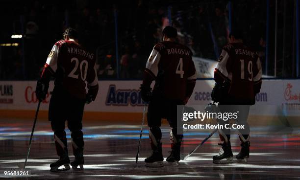 Colby Armstrong, Zach Bogosian and Marty Reasoner of the Atlanta Thrashers stand during the National Anthem before facing the New York Rangers at...