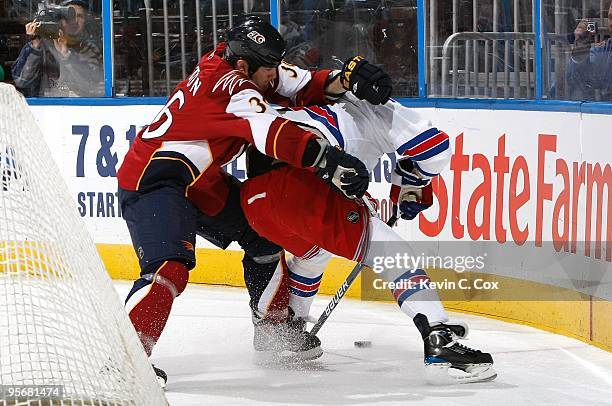 Brandon Dubinsky of the New York Rangers against Eric Boulton of the Atlanta Thrashers at Philips Arena on January 7, 2010 in Atlanta, Georgia.