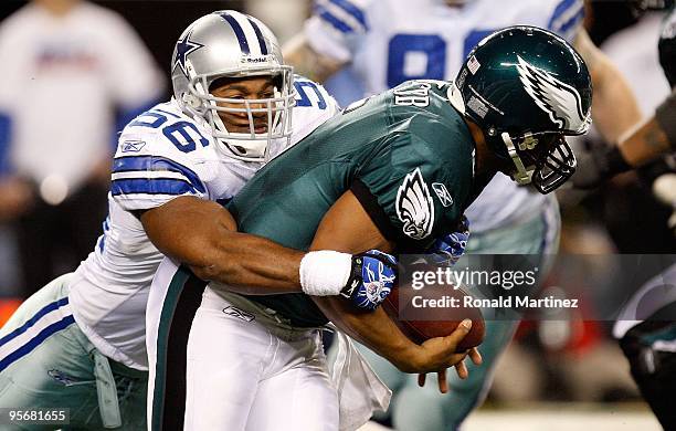 Quarterback Donovan McNabb of the Philadelphia Eagles is sacked by Bradie James of the Dallas Cowboys during the 2010 NFC wild-card playoff game at...