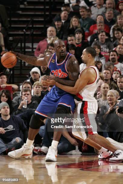 Shaquille O'Neal of the Cleveland Cavaliers looks for an opening around Juwan Howard of the Portland Trail Blazers during a game on January 10, 2009...