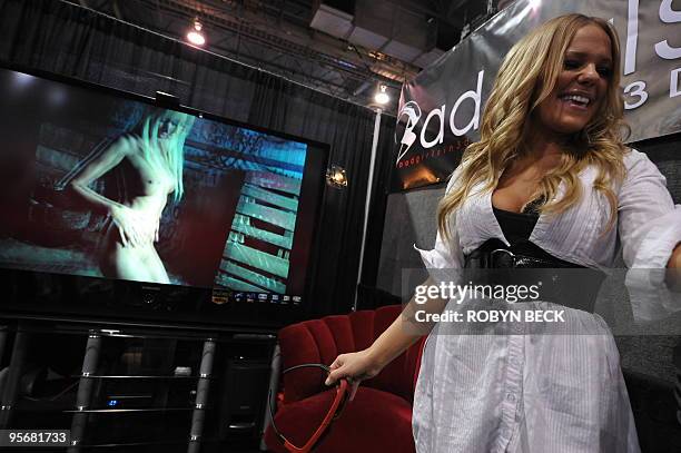 Bad Girls representative Samantha Zimmer offers 3D glasses to attendees to watch Bad Girls adult entertainment movies in 3D at the Bad Girl booth at...