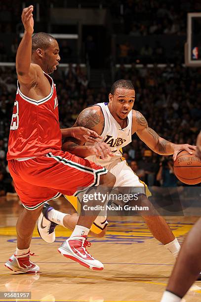 Shannon Brown of the Los Angeles Lakers drives the ball past Jodie Meeks against Milwaukee Bucks on January 10, 2010 at Staples Center in Los...