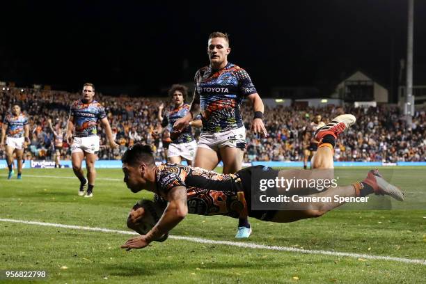 Malakai Watene-Zelezniak of the Tigers scores a try during the round 10 NRL match between the Wests Tigers and the North Queensland Cowboys at...