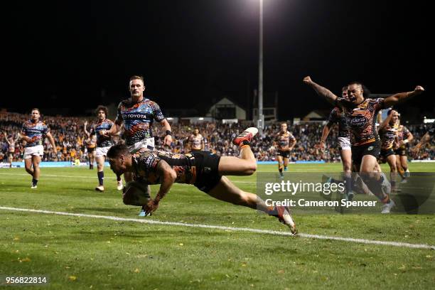 Malakai Watene-Zelezniak of the Tigers scores a try during the round 10 NRL match between the Wests Tigers and the North Queensland Cowboys at...