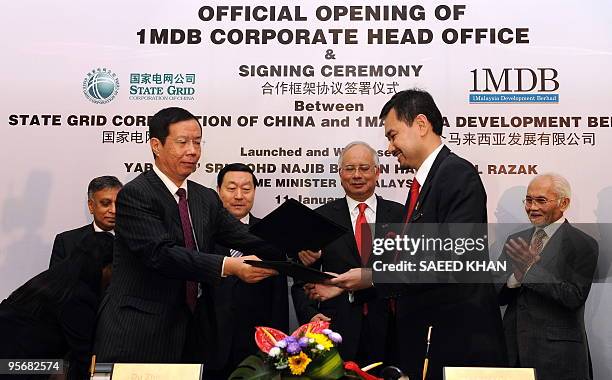 Malaysian Prime Minister Najib Razak witnesses a ceremony along with Liu Zhenya , president of State Grid Corporation of China, as Encik Shahrol...