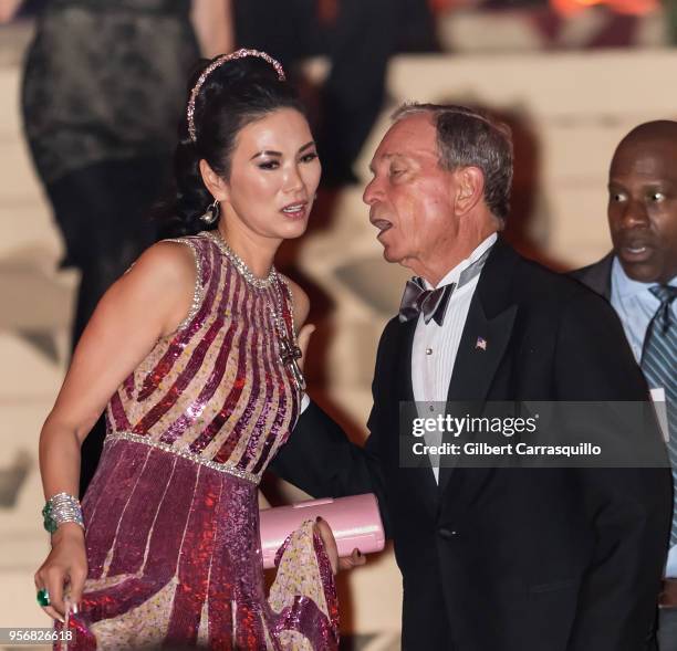 Wendi Deng Murdoch and Michael Bloomberg are seen leaving the Heavenly Bodies: Fashion & The Catholic Imagination Costume Institute Gala at The...