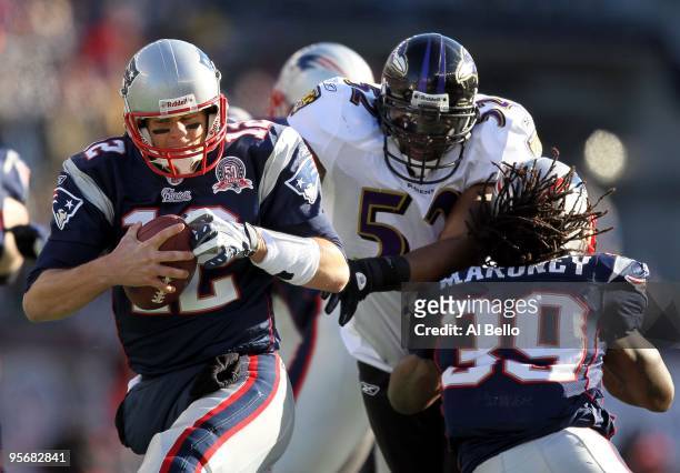Tom Brady of the New England Patriots attempts to avoid the pass rush as Laurence Maroney throws a block against Ray Lewis of the Baltimore Ravens...