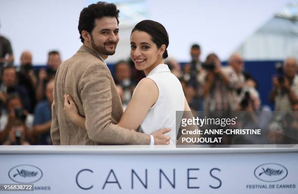 Egyptian director A.B Shawky and producer Dina Emam pose on May 10, 2018 during a photocall for the film "Yomeddine" at the 71st edition of the...