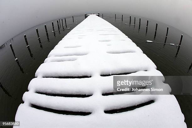 Snow covers a dock at Ammersee lake on January 11, 2010 in Schondorf am Ammersee, Germany. Depression 'Daisy' brought havoc in Germany as treacherous...