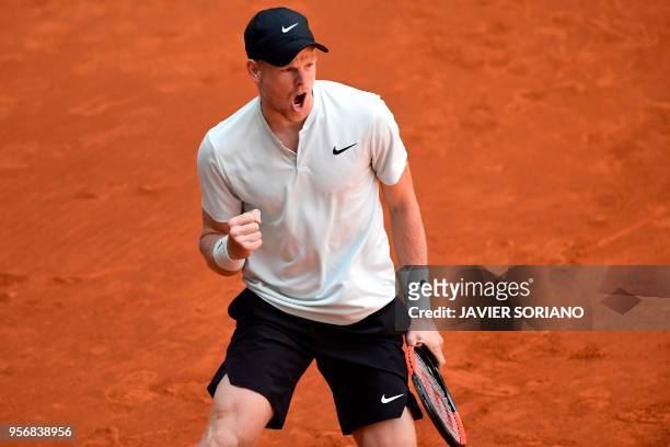 Britain's Kyle Edmund reacts after winning a point against Belgium's David Goffin during their ATP Madrid Open round of 16 tennis match at the Caja...