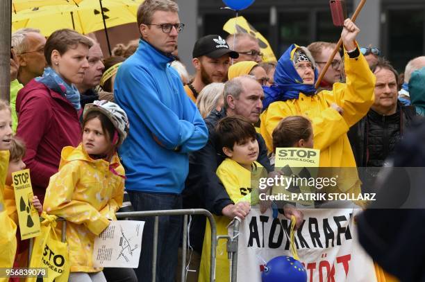 Anti-nuclear protesters hold placard against Belgium's Tihange 2 and the Netherland's Doel 3 nuclear power plants outside the city hall where the...