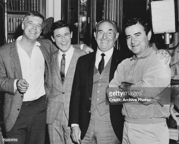 Actors George Peppard and Roddy McDowall , producer Jack Warner and director Jack Smight , possibly on the set of Smight's film 'The Third Day', 1965.