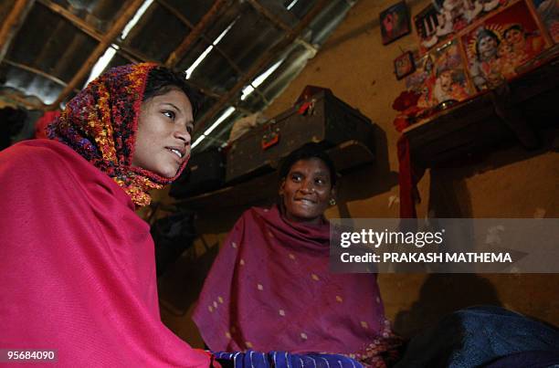 Nepal-rights-prostitution,FEATURE by Claire Cozens Nepalese woman Durbati Nepali looks at her daughter Binita Nepali as she gives an interview to AFP...