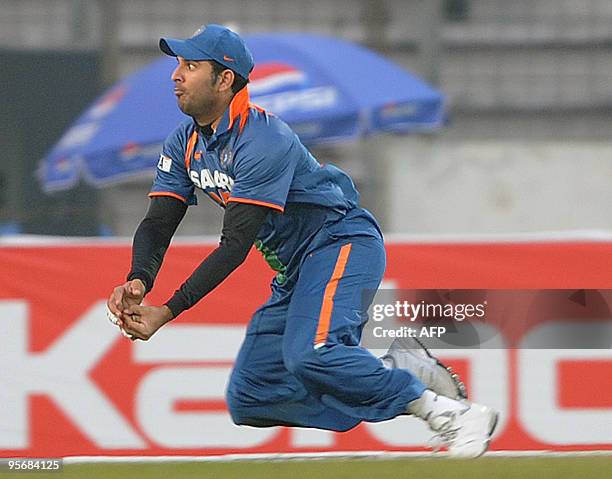 Indian cricketer Yuvraj Singh catches a ball during the Tri-Nation tournament One Day International cricket match between India and Sri Lanka at The...