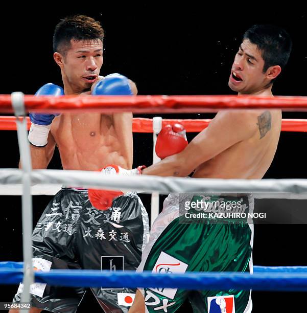 Challenger Takashi Uchiyama of Japan lands a left on champion Juan Carlos Salgado of Mexico in the WBA super featherweight title boxing match at...