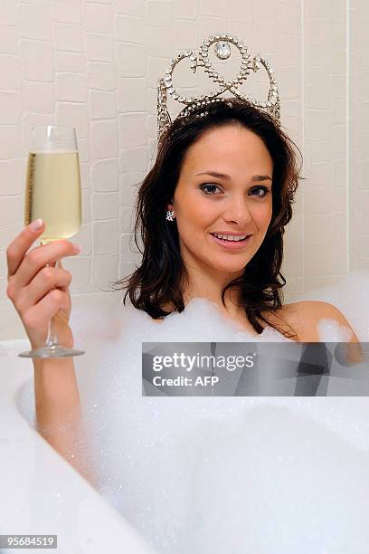 Miss Belgium 2010, Cilou Annys from Brugge, Western Flanders, poses for photographers in a bubble bath with a glass of champagne on January 11, 2010...