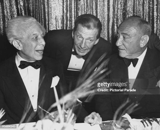 American cinema owner Sid Grauman , actor Frank Fay and American film executive Joseph Schenck at a testimonial dinner for Grauman, circa 1945.