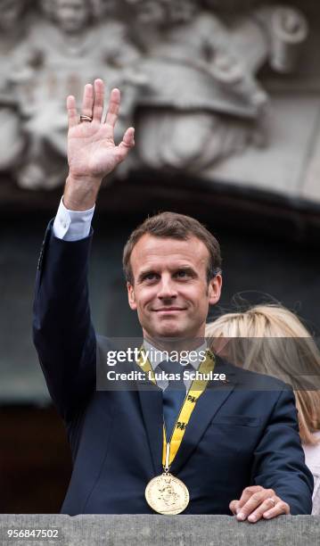 French President Emmanuel Macron waves from the balcony of the town hall of Aachen after Macron recieved the International Charlemagne Prize at a...