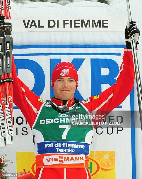 Bill Demong celebrates on the podium after winning the Gundersen Combined competition event of the FIS Nordic Combined World Cup in Alpe's Cermins in...