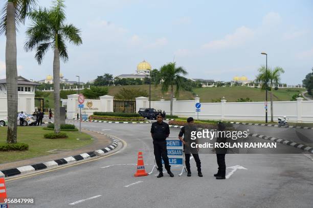 Malaysia police officers stand guard outside the Istana Negara where former Malaysian prime minister and opposition candidate Mahathir Mohamad...