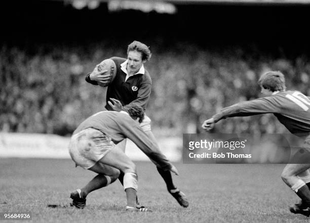 John Rutherford of Scotland is tackled by David Pickering of Wales during the Wales v Scotland Rugby Union International played at Cardiff Arms Park...