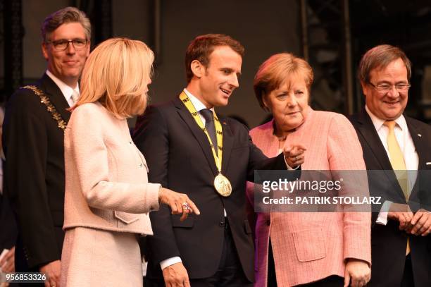 France's President Emmanuel Macron talks to Germany's Chancellor Angela Merkel as his wife Brigitte Macron and North Rhine-Westphalia's State Premier...