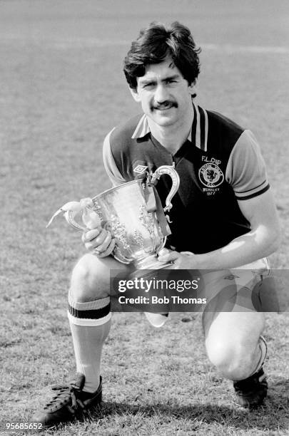 Aston Villa captain Dennis Mortimer poses with the League Cup, at Villa's Bodymoor Heath training ground near Birmingham, 19th April 1977. Aston...