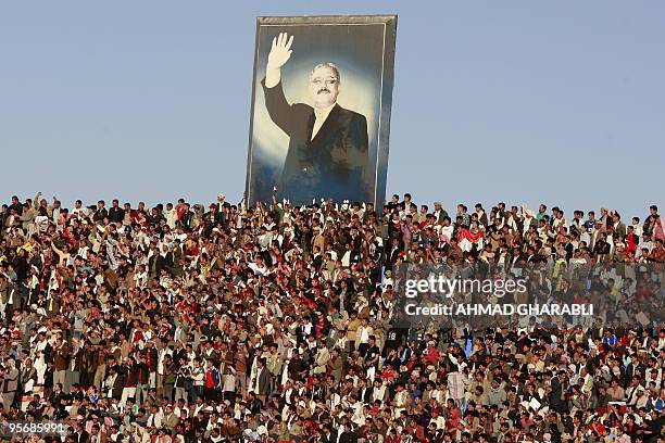 Yemeni fooball fans cheer their team under a portrait of their president Ali Abdullah Saleh during the Group A Asian Cup 2011 qualifying match...