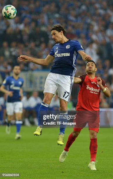 Benjamin Stambouli of Schalke and Marco Fabian of Frankfurt battle for the ball during the DFB Cup semi final match between FC Schalke 04 and...