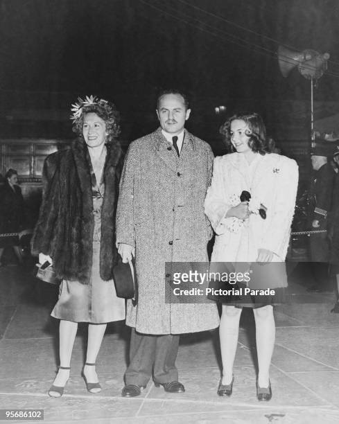 American film producer and screenwriter Darryl F. Zanuck with his wife, actress Virginia Fox , and their daughter Darrilyn, outside Grauman's Chinese...