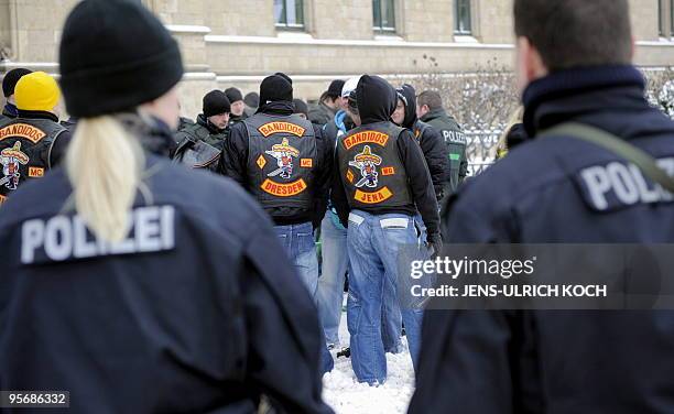 Members of the motorcycle gang "Bandidos" arrive for the trial of 6 of its members under the watchful eye of the police in the eastern German city of...